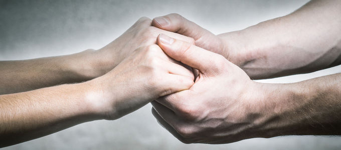 People holding hands - Grief counselling